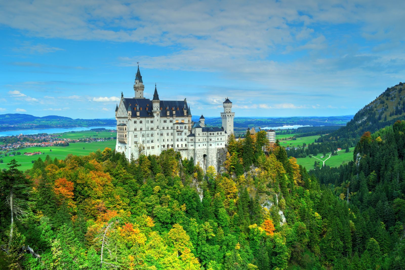 Neuschwanstein Castle above autumn forests in Bavaria, Germany